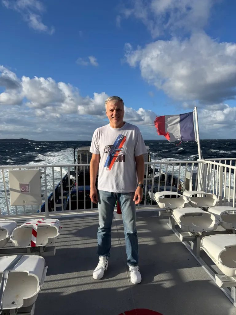 He’s probably thinking “Merci à Dieu pour la France!” while wearing an inappropriate-for-the-occasion Deutschland BMW 3.0CS tshirt