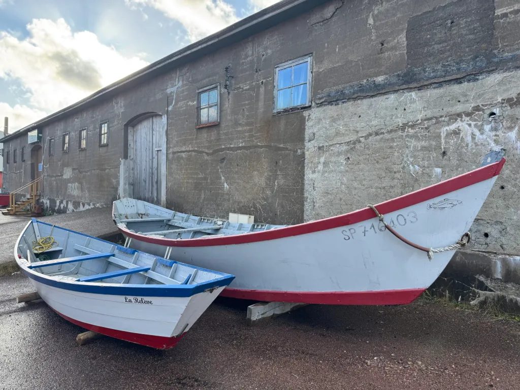 Traditional dory (fishing boat), in front of a very French looking building